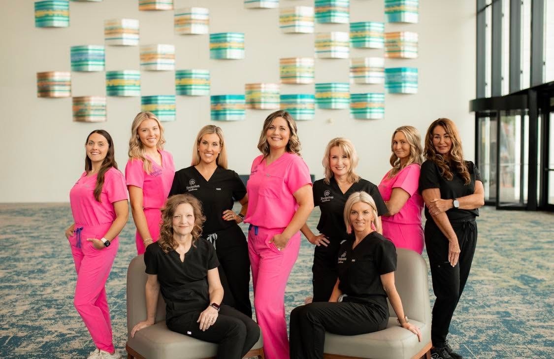 Evolution Wellness team in pink and black scrubs